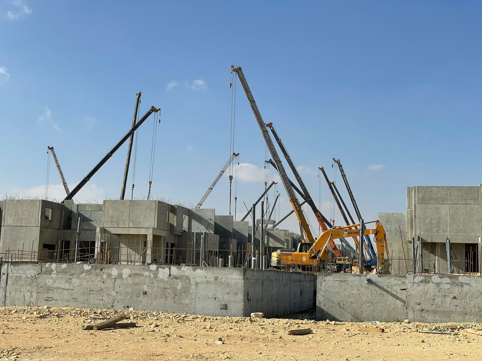 Mobile cranes staged for panel erection