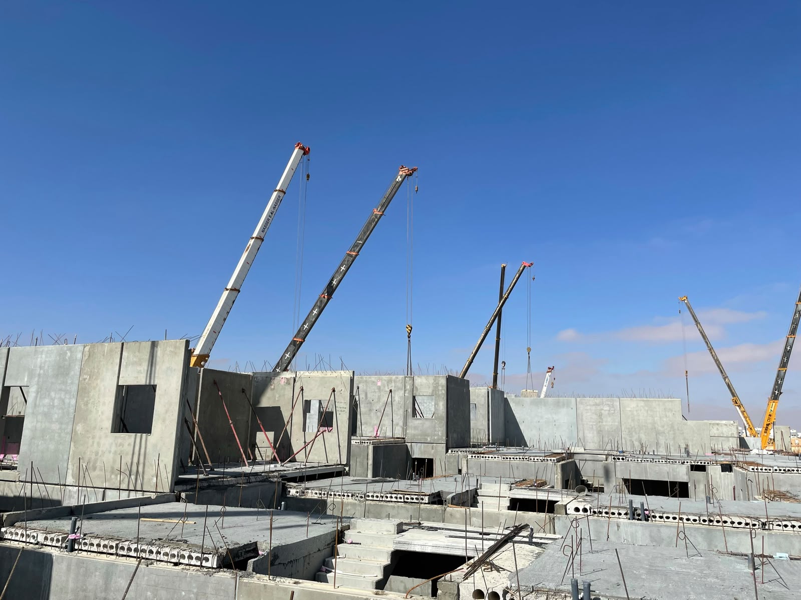 Precast concrete wall panels being lifted and erected