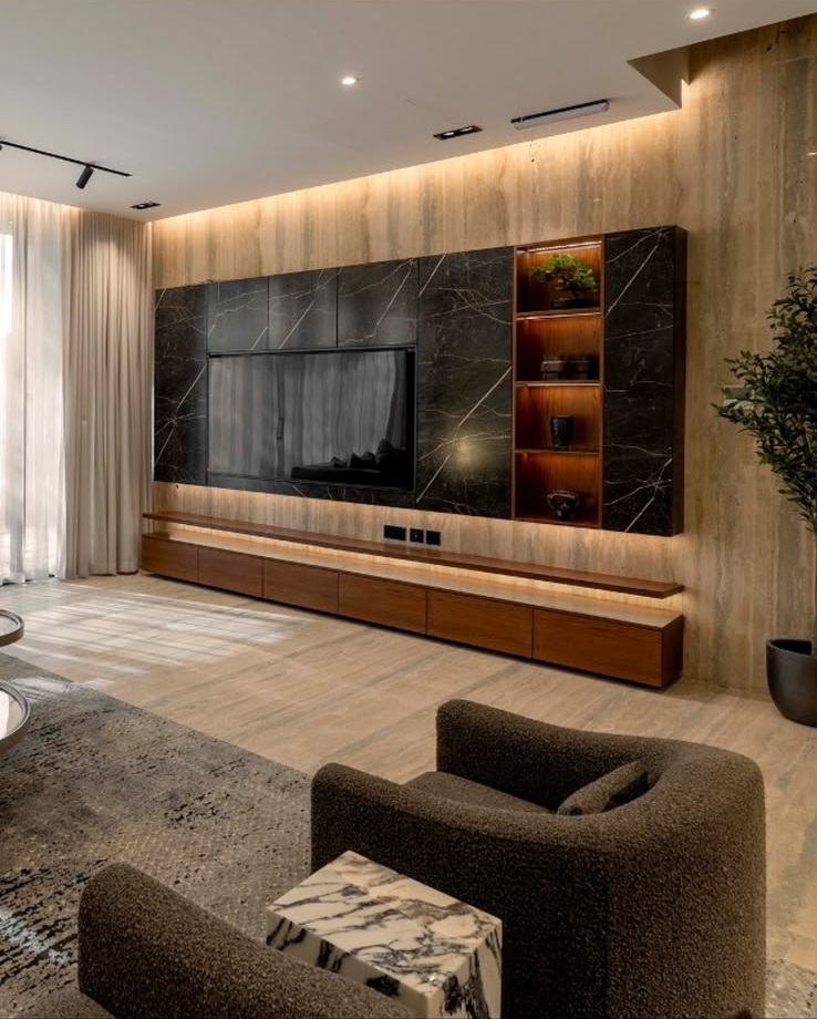 Al Habib villa living room with travertine wall and integrated media console
